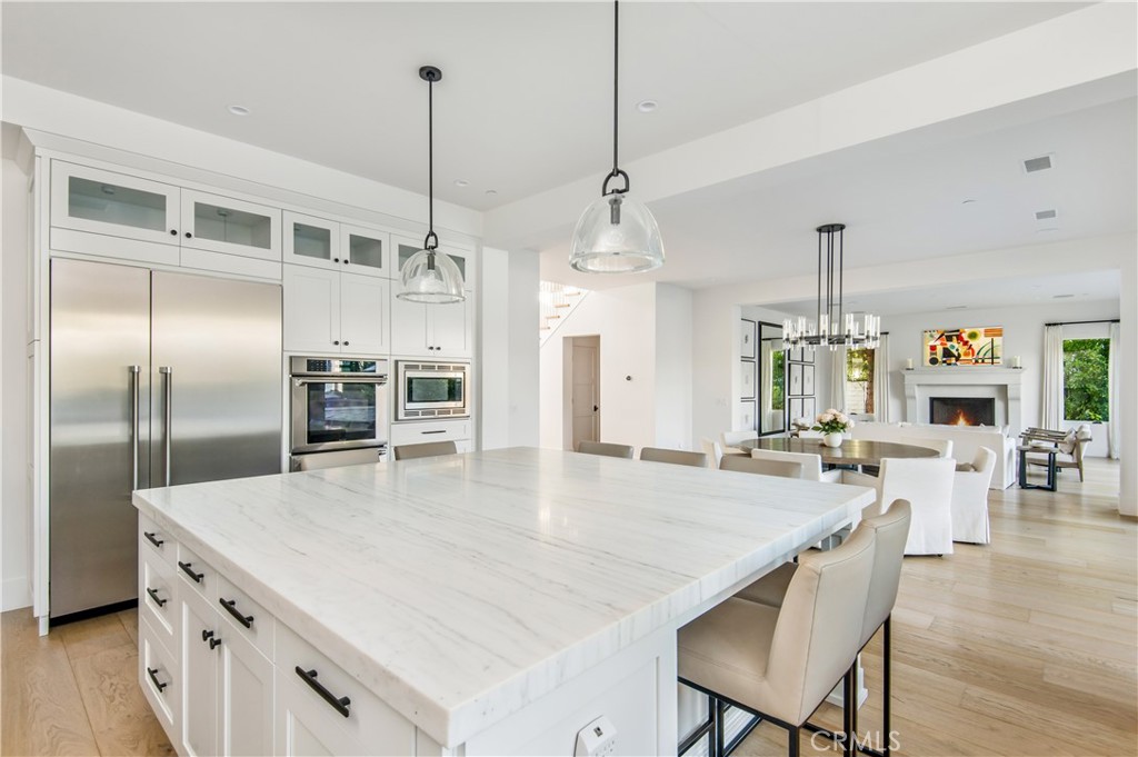 28750 Martingale Drive San Juan Capistrano, CA 92675 - Photo 10 of 45 a kitchen with stainless steel appliances granite countertop a kitchen island a stove a table and chairs