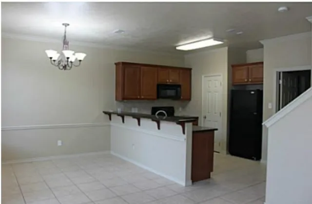 a view of a kitchen with a sink and chandelier
