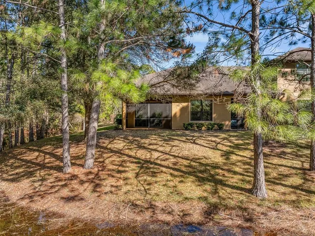an aerial view of a swimming pool patio and outdoor seating