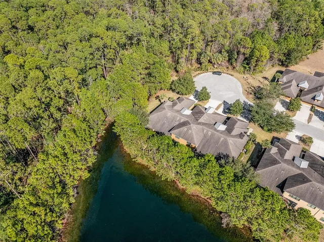 an aerial view of a house with a lake view