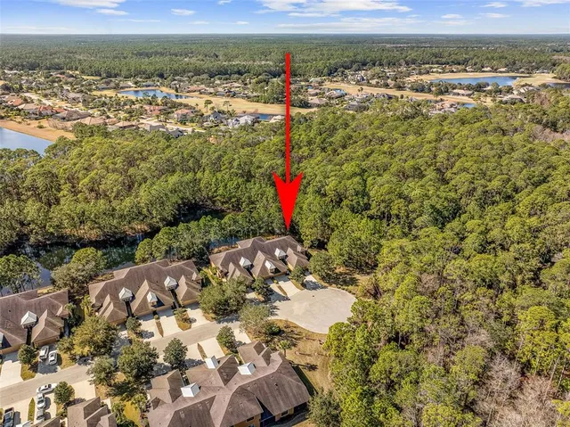 an aerial view of residential houses with outdoor space and swimming pool