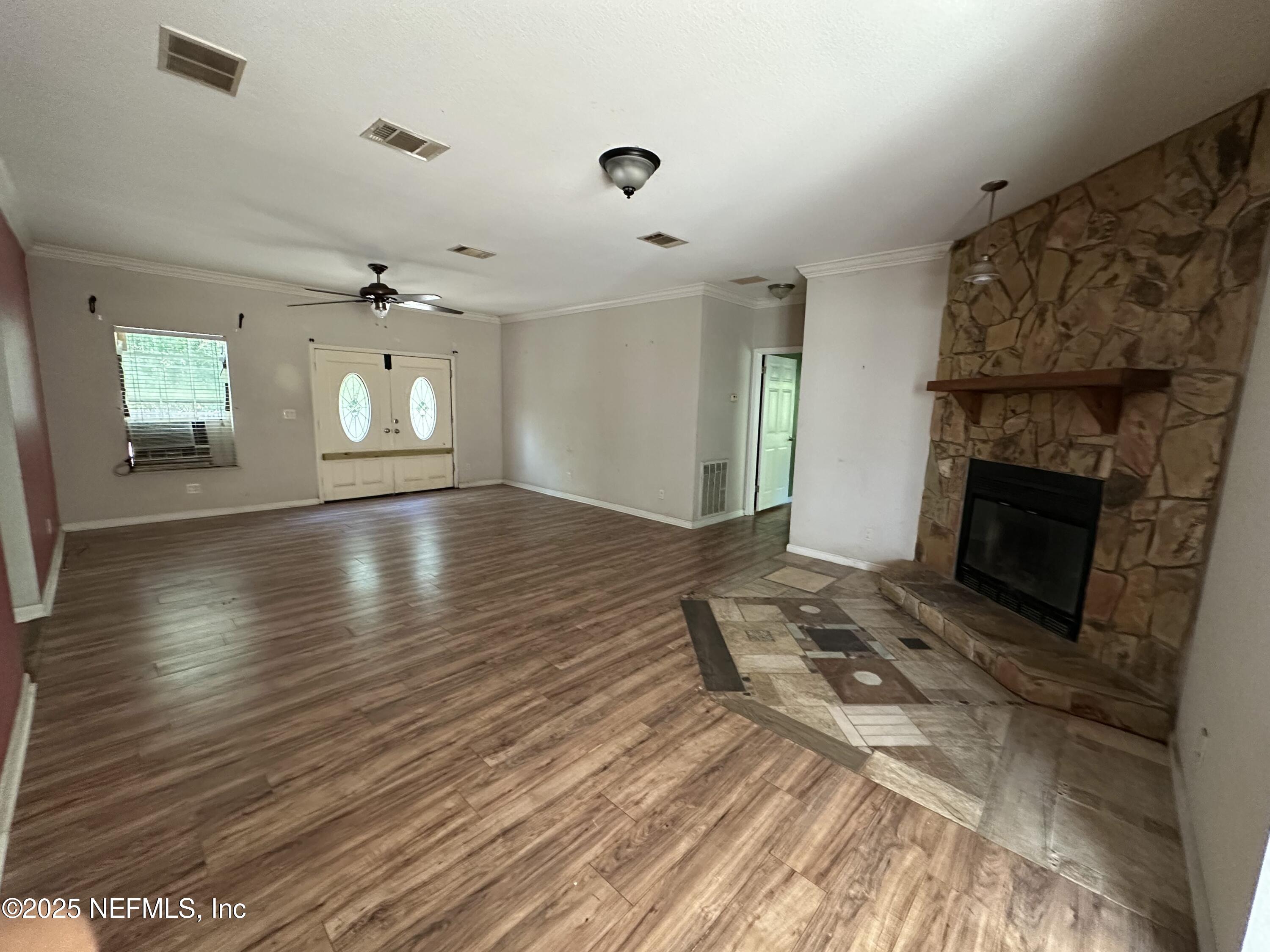 852030 Highway 17 Yulee, FL 32097 - Photo 13 of 21 an empty room with wooden floor fireplace and windows