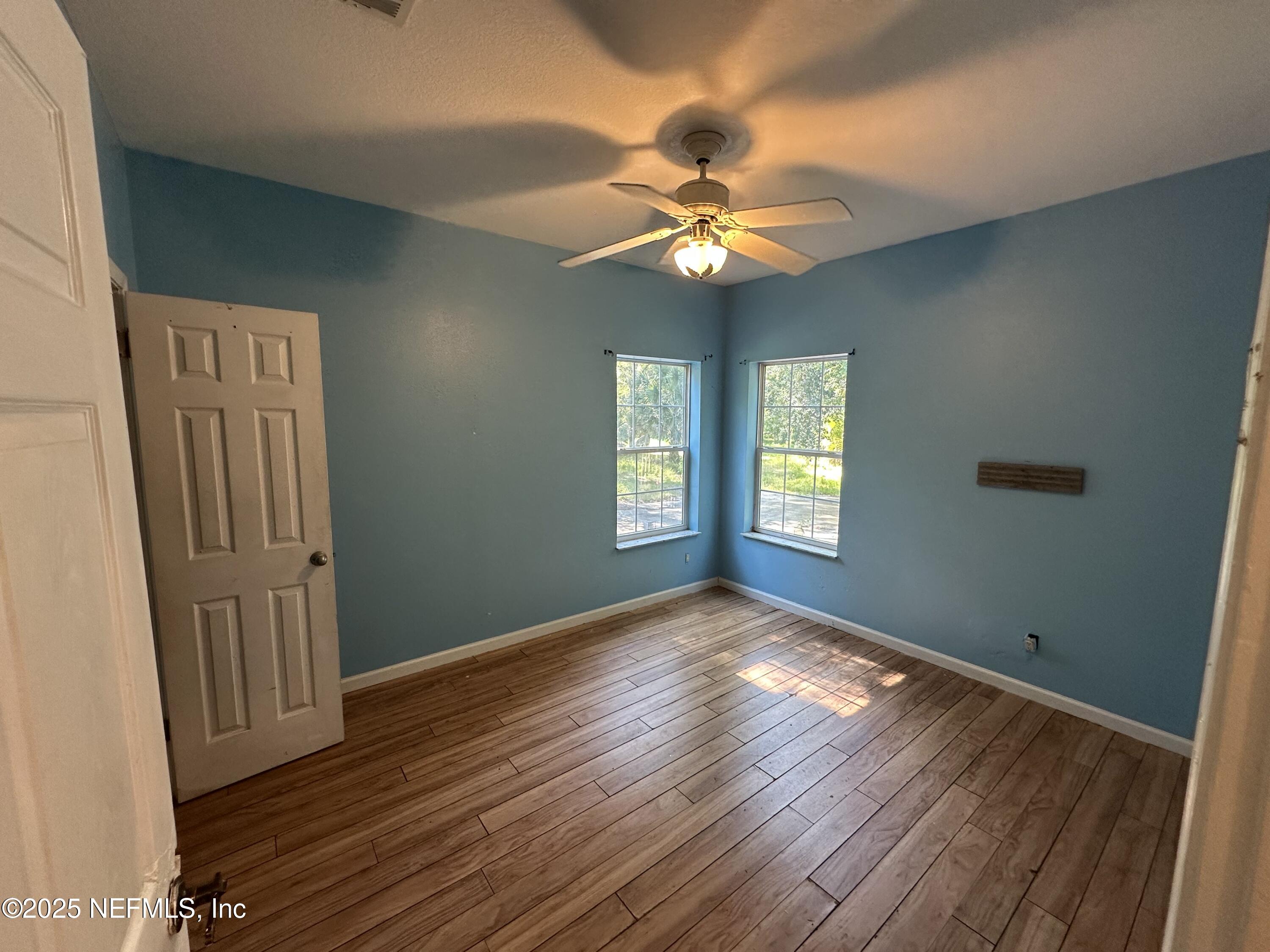 852030 Highway 17 Yulee, FL 32097 - Photo 17 of 21 a view of an empty room with window and wooden floor