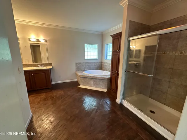 a bathroom with a tub a sink and a mirror