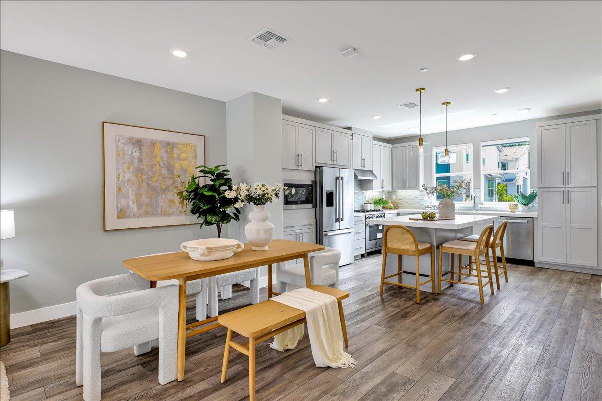 122 Ranch Lane Mountain View, CA 94040 - Photo 17 of 69 a dining room with furniture a wooden floor and kitchen view