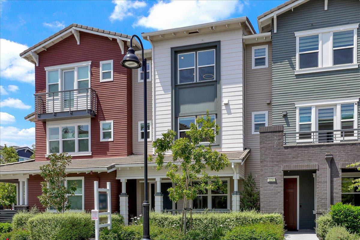 122 Ranch Lane Mountain View, CA 94040 - Photo 2 of 69 a yellow building with potted plant in front of it