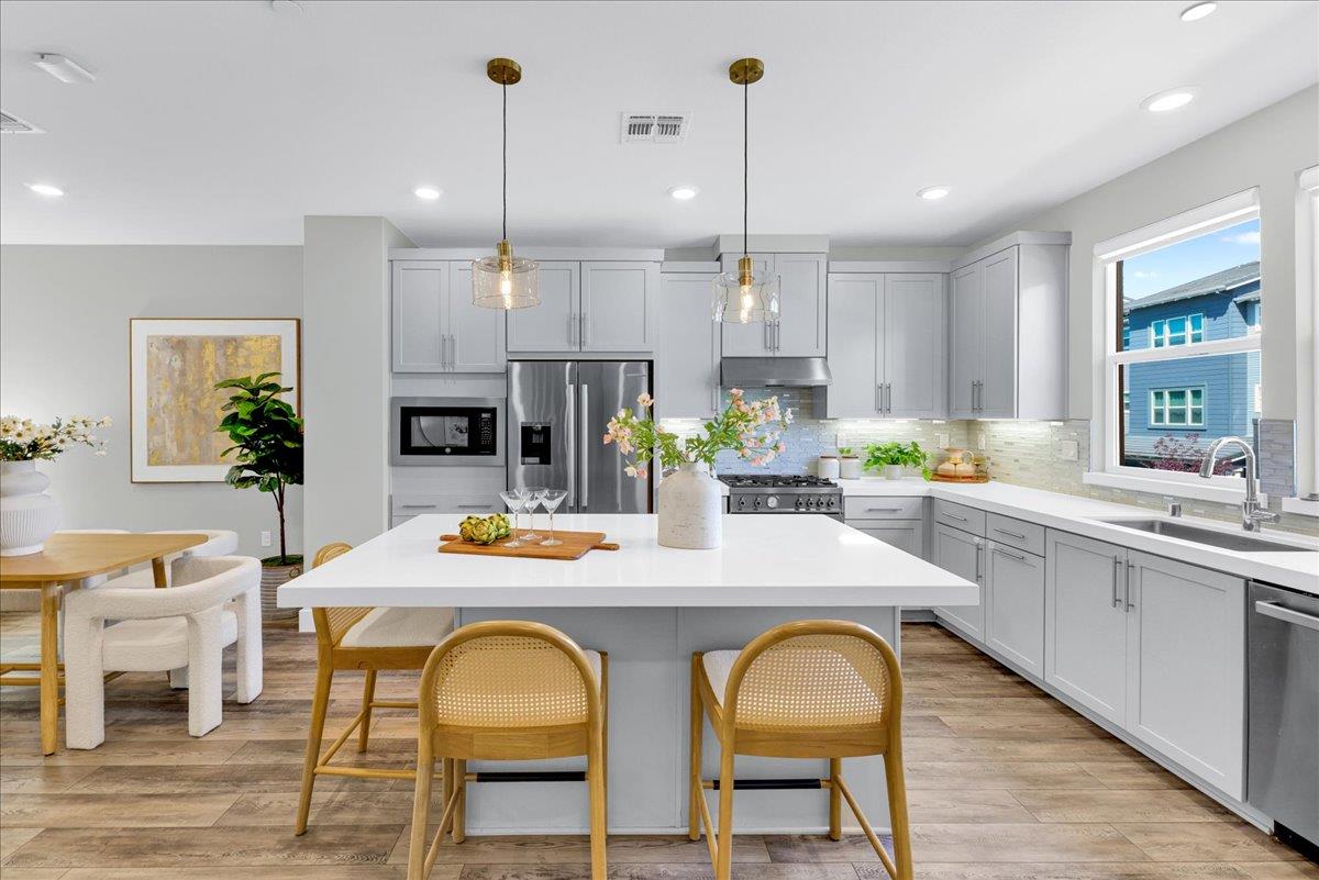 122 Ranch Lane Mountain View, CA 94040 - Photo 22 of 69 a kitchen with stainless steel appliances granite countertop a kitchen island a stove a table and chairs