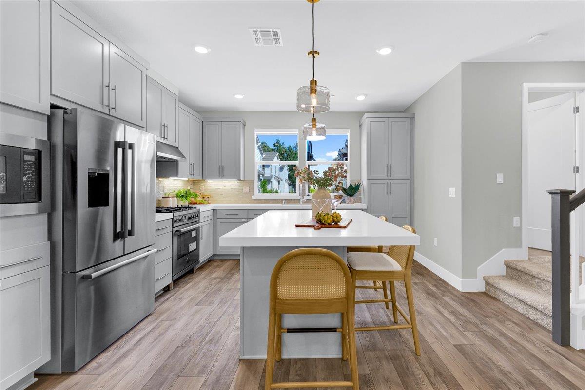 122 Ranch Lane Mountain View, CA 94040 - Photo 23 of 69 a kitchen with a table chairs refrigerator and microwave