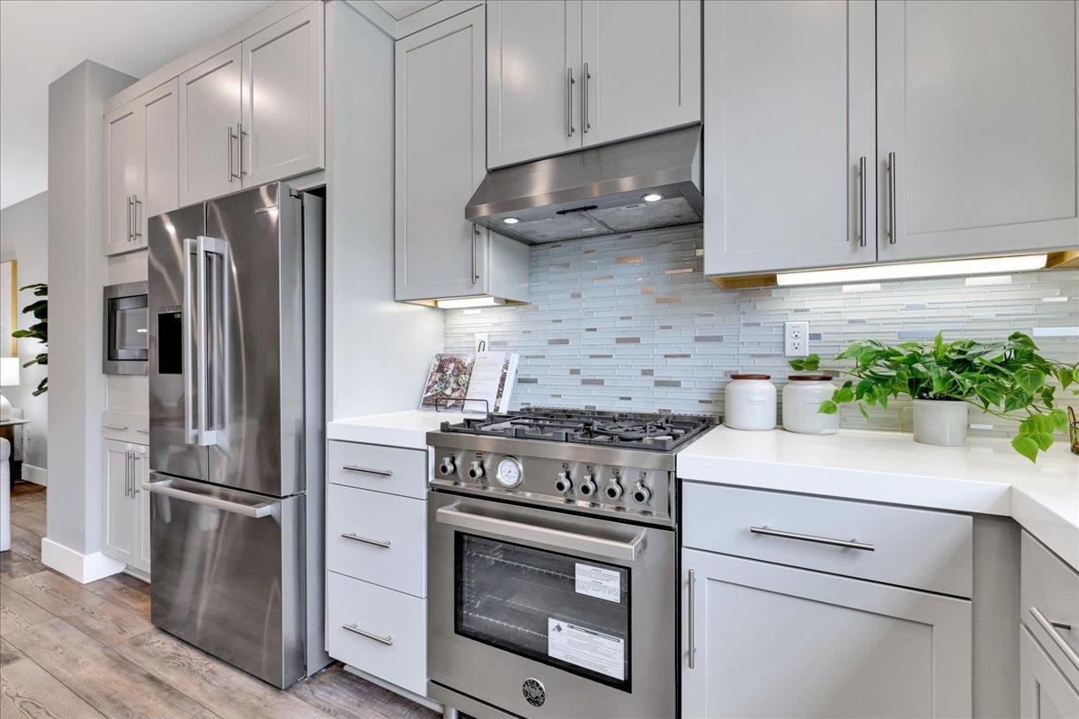 122 Ranch Lane Mountain View, CA 94040 - Photo 28 of 69 a kitchen with stainless steel appliances white cabinets and a stove top oven