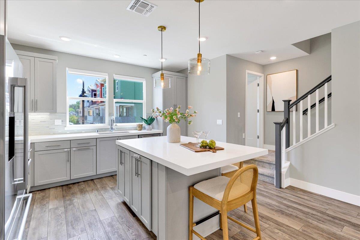 122 Ranch Lane Mountain View, CA 94040 - Photo 29 of 69 a kitchen with sink cabinets and wooden floor