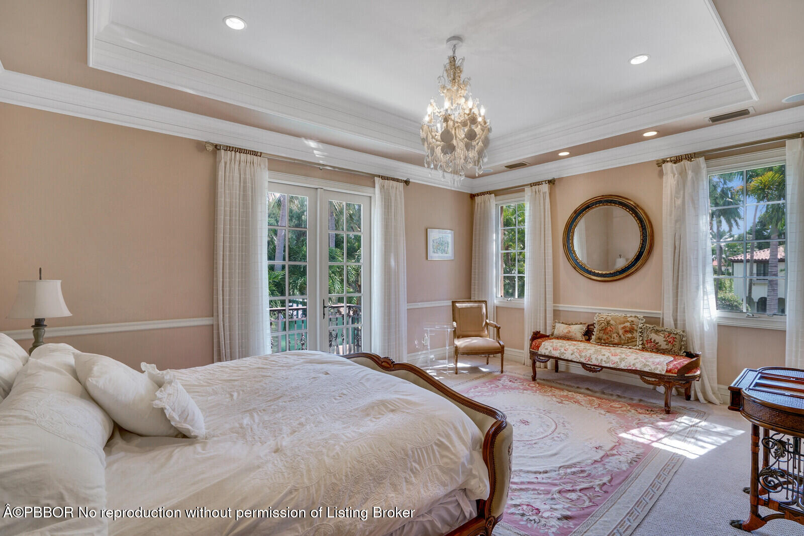 231 Wells Road Palm Beach, FL 33480 - Photo 33 of 39 a spacious bedroom with a bed a chandelier and a large window