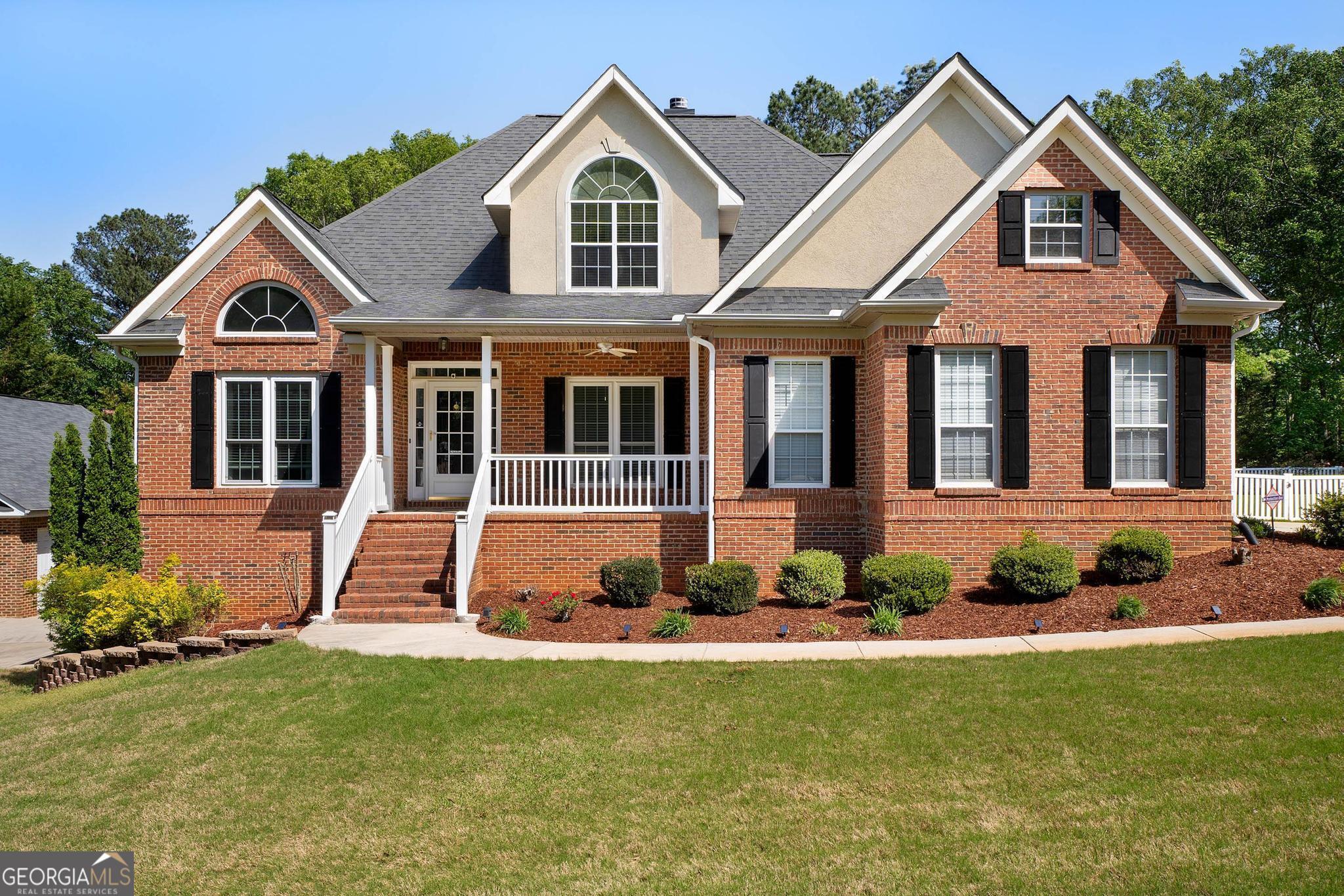 a front view of a house with a yard
