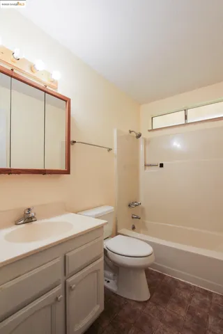 a bathroom with a toilet a sink and a shower