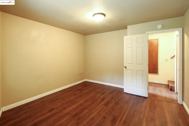 a view of a room with wooden floor