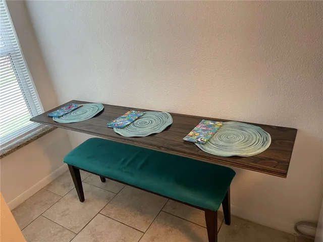 a view of a room that has a table and chairs