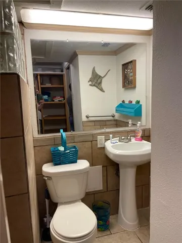 a bathroom with a sink toilet and mirror