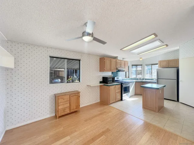 a living room with stainless steel appliances kitchen island granite countertop furniture and a kitchen view
