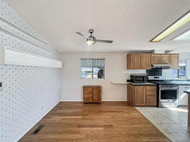 a kitchen with stainless steel appliances granite countertop a stove and a sink