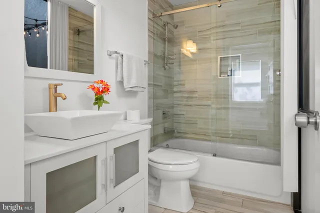 a bathroom with a sink toilet and shower