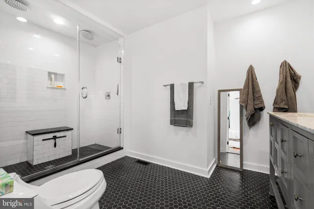 a bathroom with a toilet a sink and shower