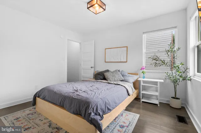 a bedroom with a bed and a painting on the wall