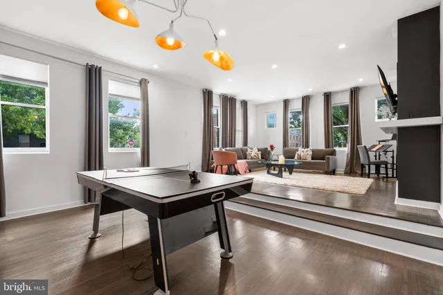 a view of a dining room with furniture a chandelier and wooden floor
