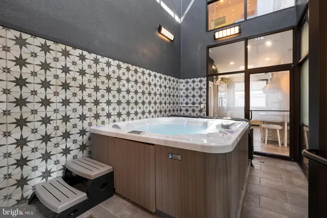 a bathroom with a granite countertop sink and a bathtub