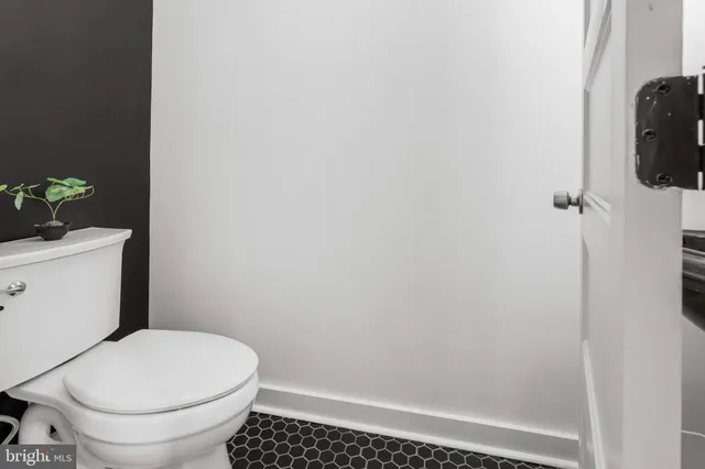 a white toilet sitting next to a shower