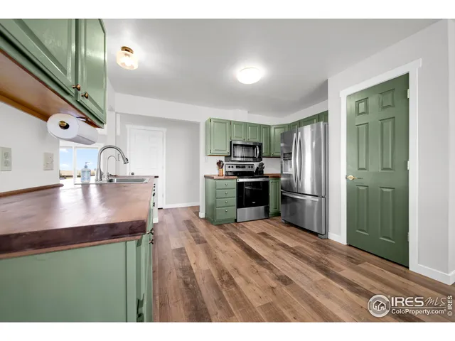 a kitchen with kitchen island a sink stainless steel appliances and cabinets