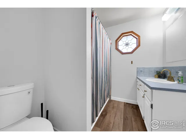 a bathroom with a toilet a sink and a mirror