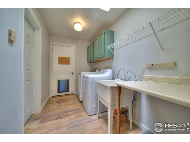 a kitchen with a sink cabinets and wooden floor