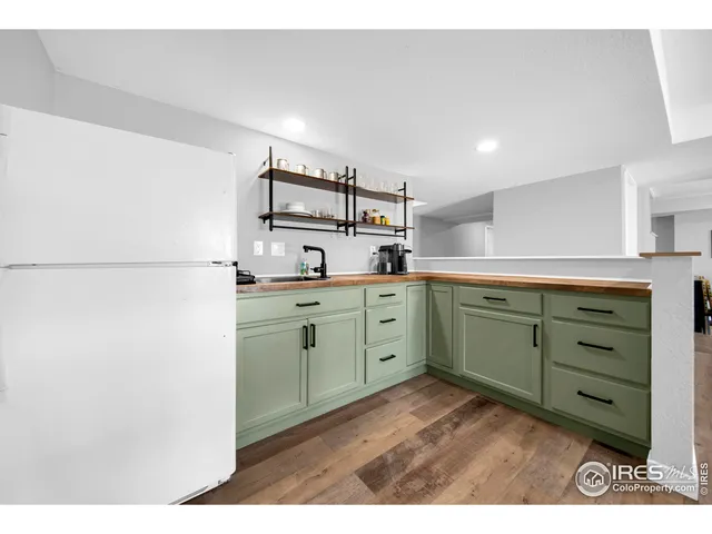a kitchen with a refrigerator and cabinets