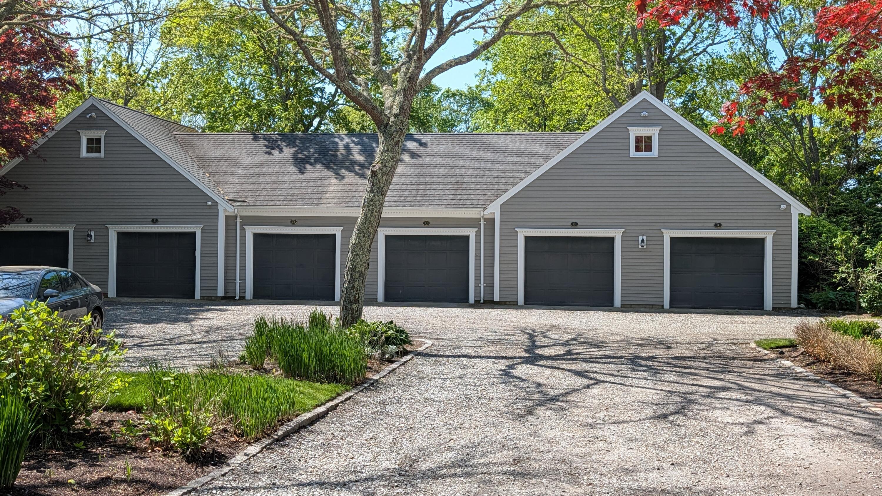 105 Parker Road, Unit B Osterville, MA 02655 - Photo 6 of 33 a front view of a house with a yard and garage