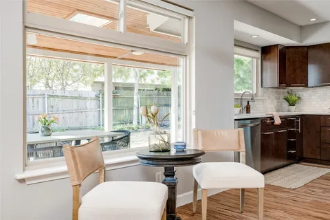 a living room with furniture a large window and a table