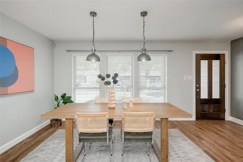 a dining room with furniture and window