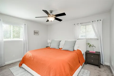 a bed sitting in a bedroom next to a window