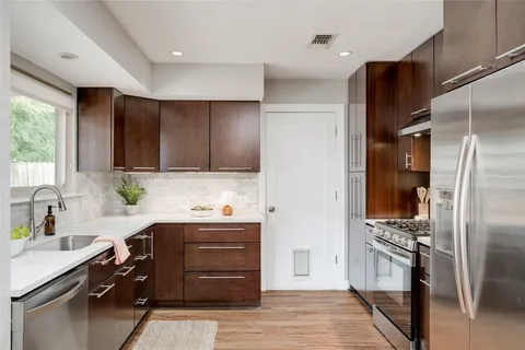 a kitchen with a refrigerator and a sink