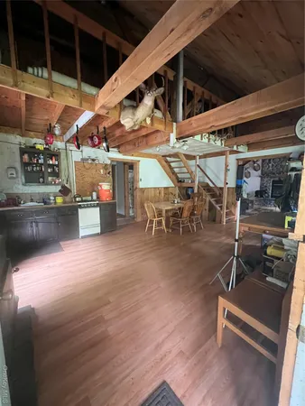 a view of a room with wooden floor