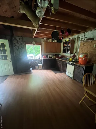 a view of a room with wooden floor