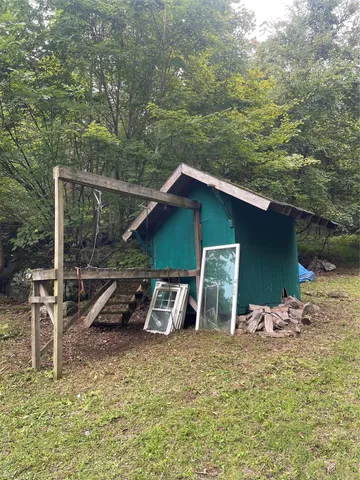 a backyard of a house with table and chairs