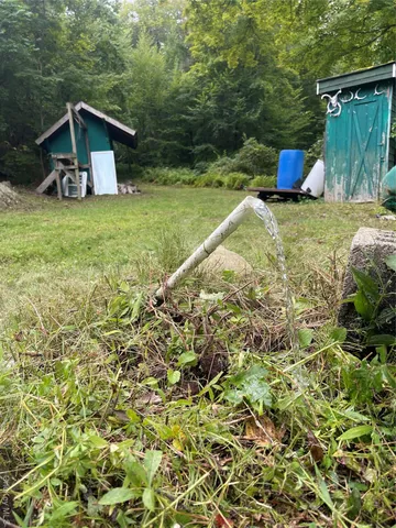a view of a tiny house with a yard