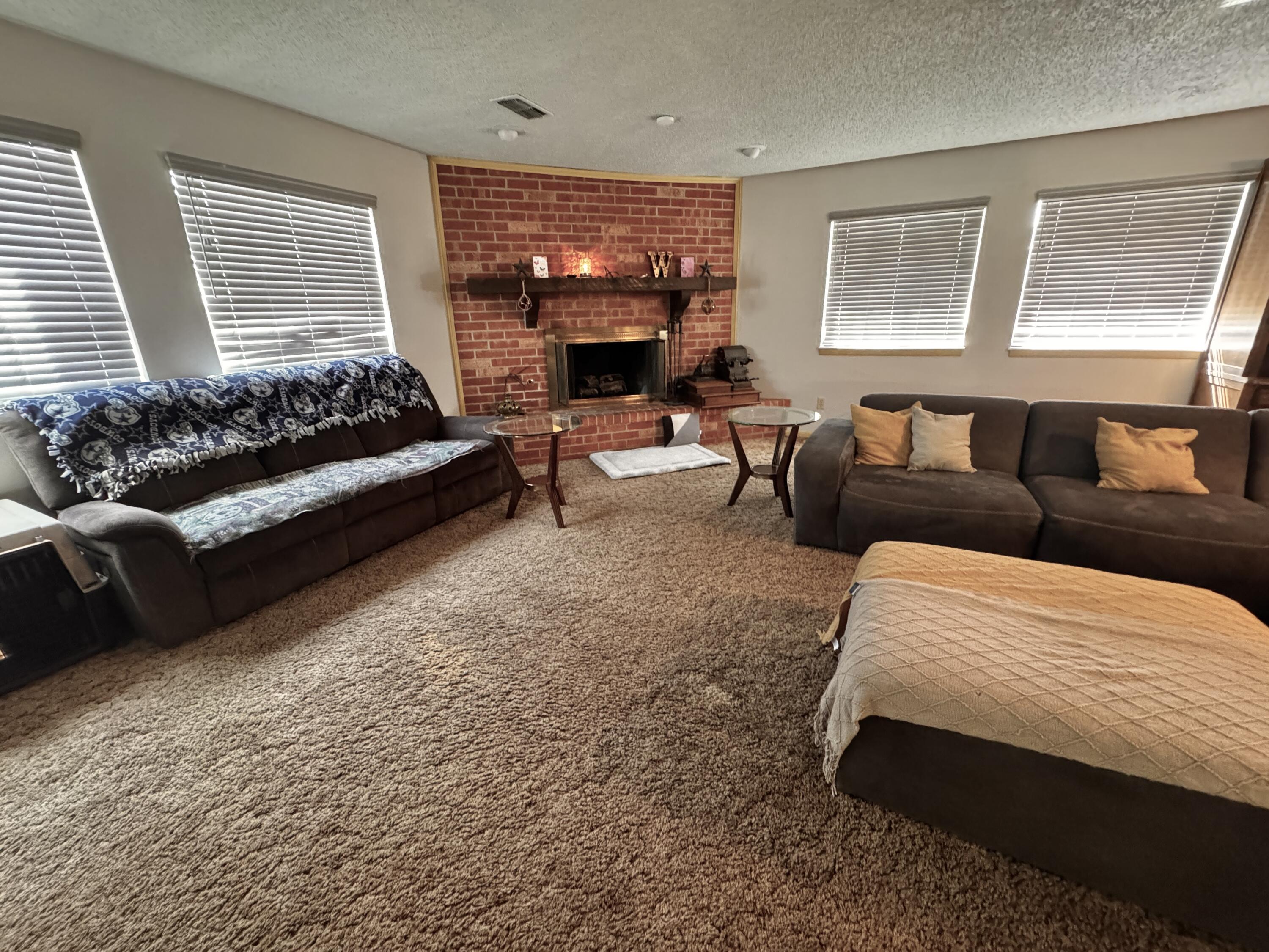 1720 Canyon Plainview, TX 79072 - Photo 11 of 49 a bedroom with furniture and a fireplace