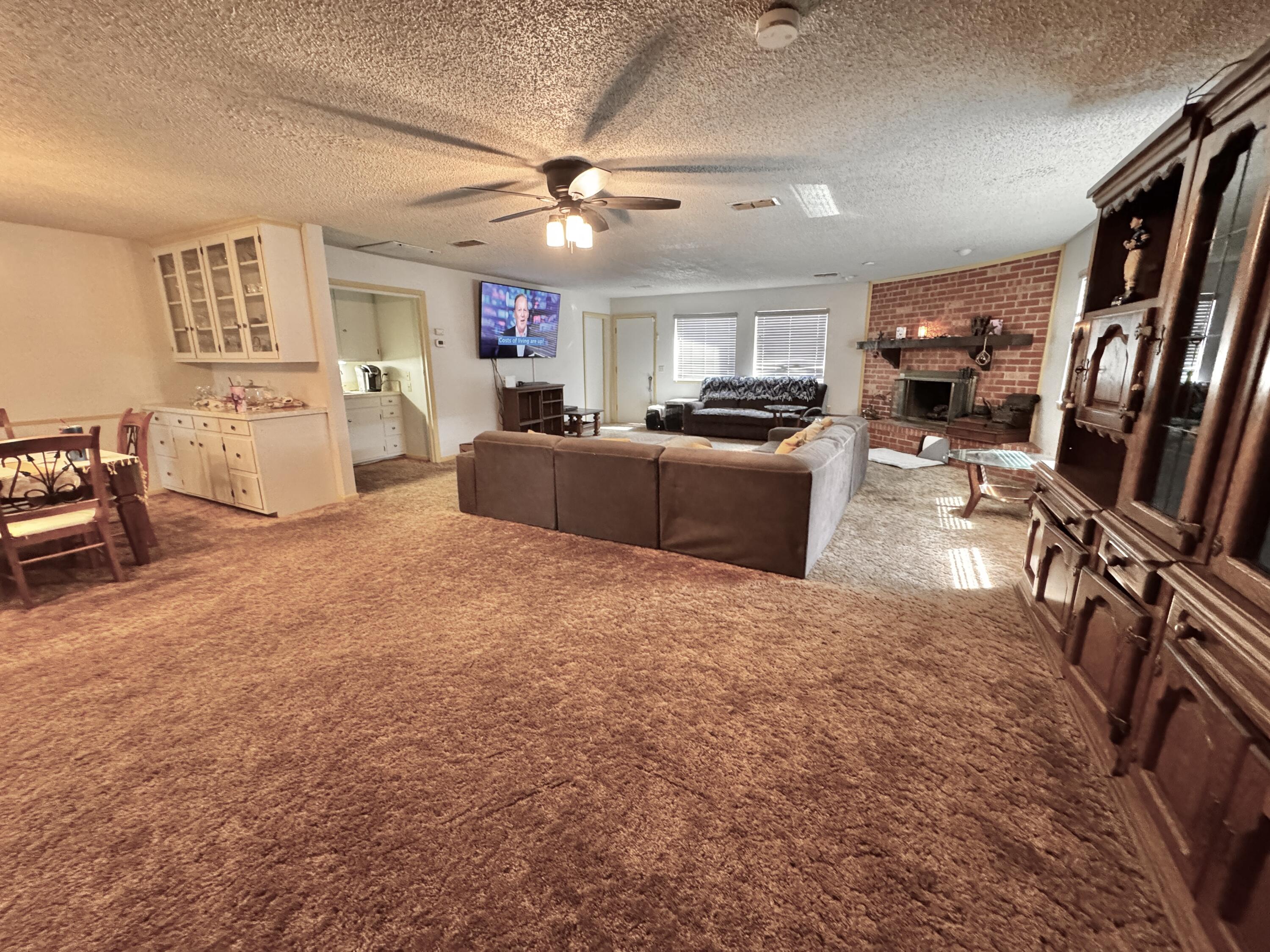 1720 Canyon Plainview, TX 79072 - Photo 12 of 49 a living room with furniture and a flat screen tv