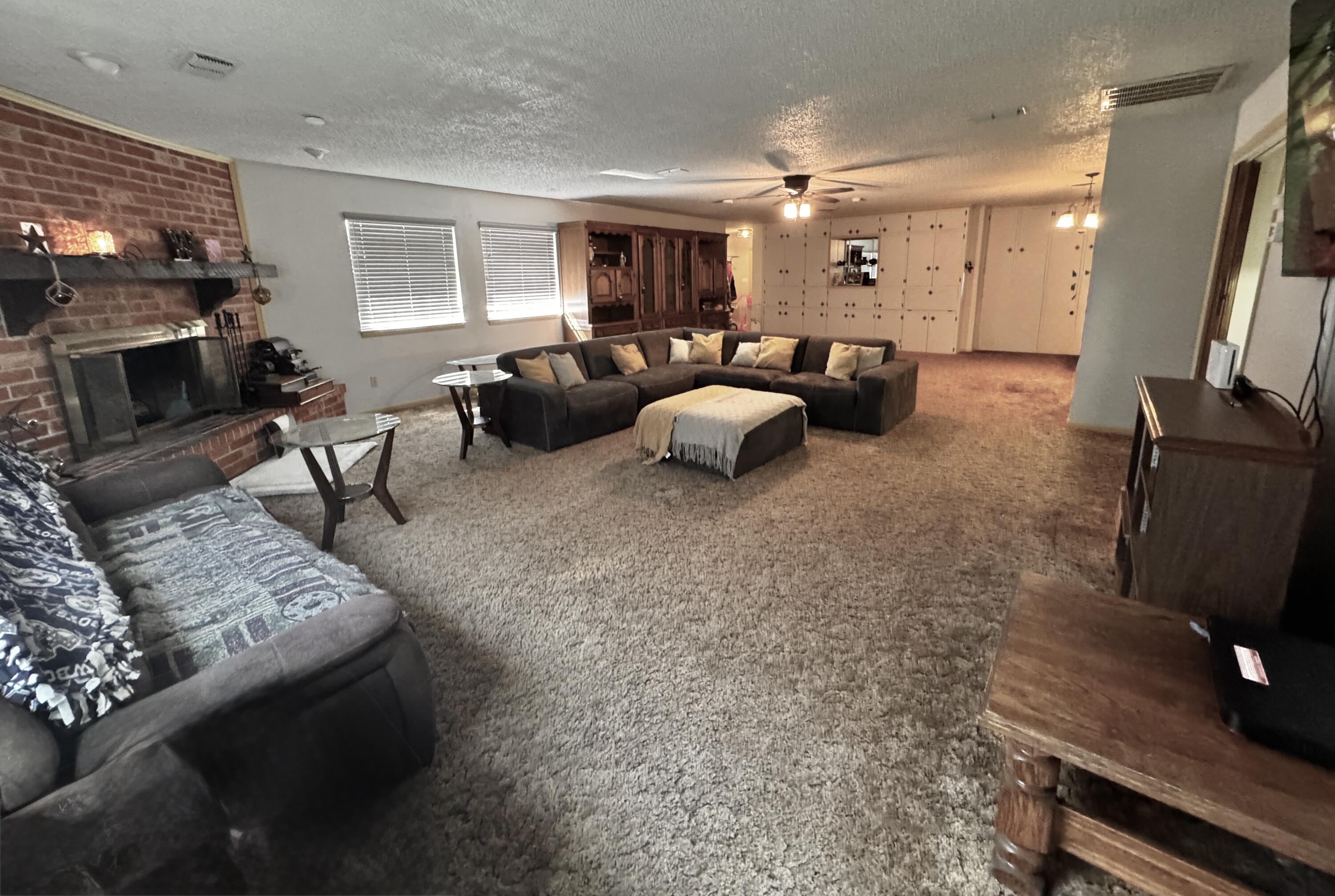 1720 Canyon Plainview, TX 79072 - Photo 13 of 49 a living room with furniture and a flat screen tv