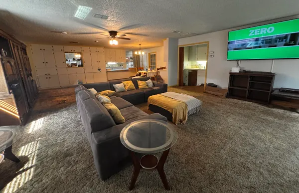 a living room with furniture a rug and a fireplace