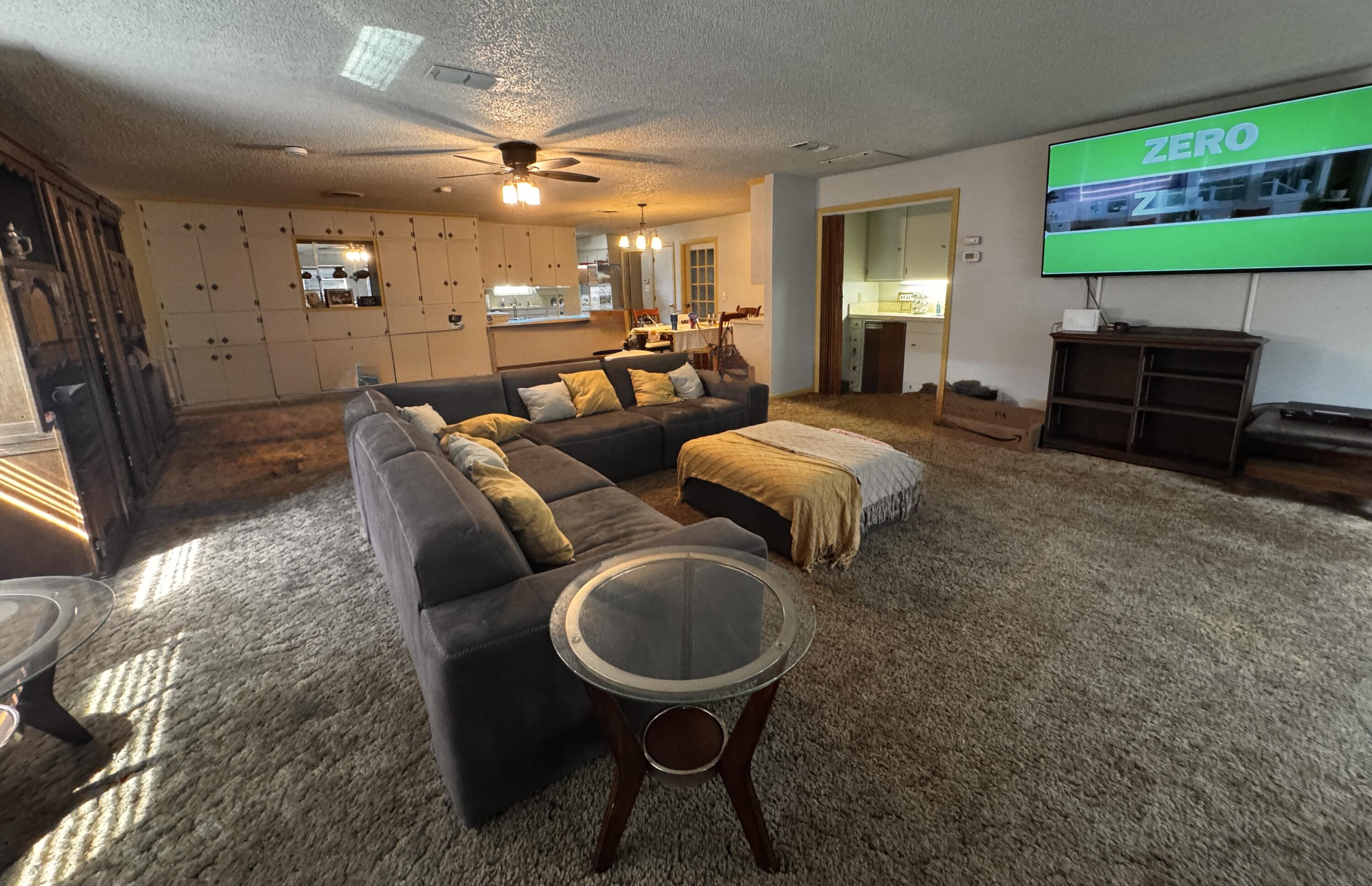 1720 Canyon Plainview, TX 79072 - Photo 14 of 49 a living room with furniture a rug and a fireplace