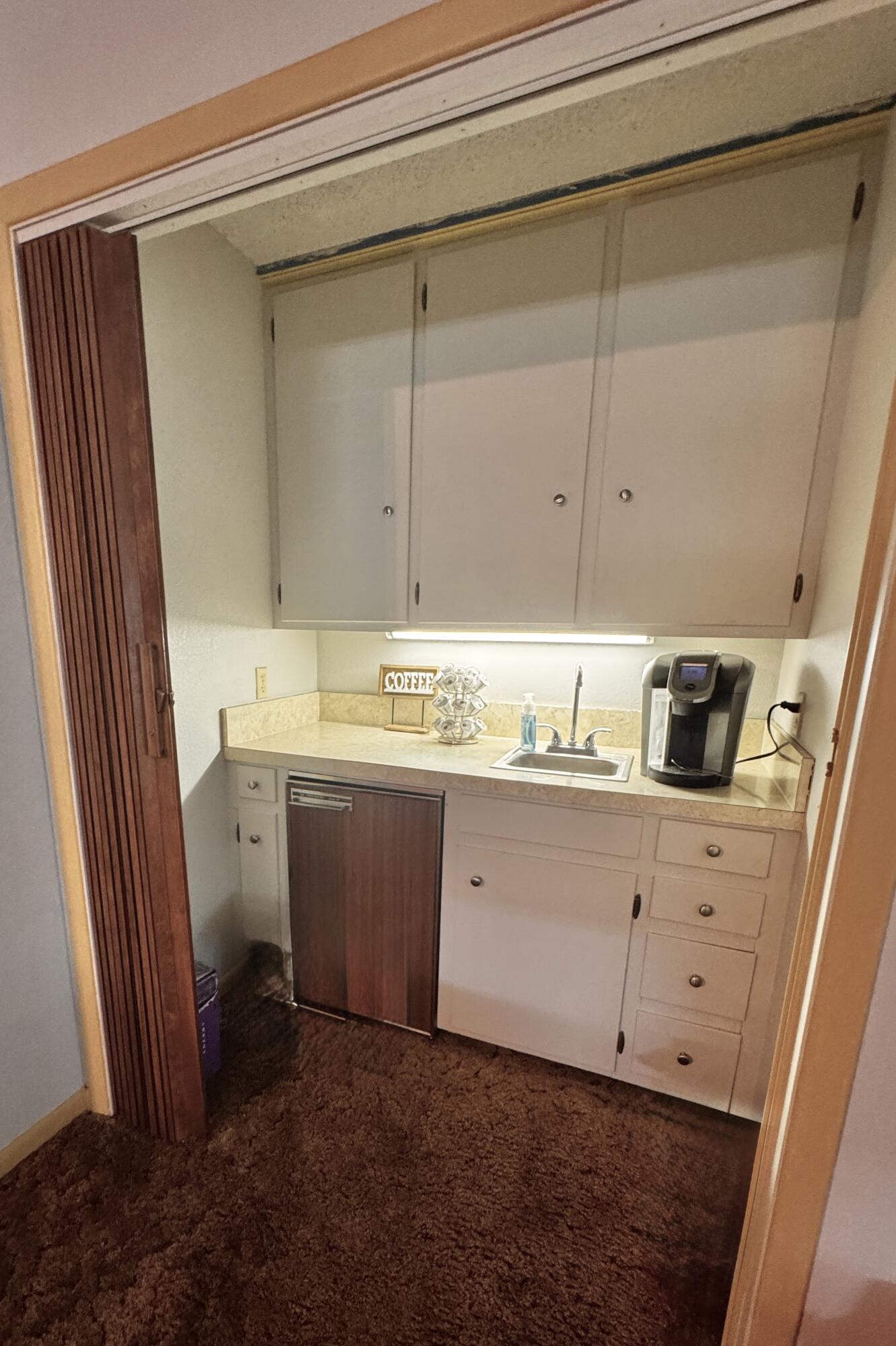 1720 Canyon Plainview, TX 79072 - Photo 16 of 49 a room with a sink a washer and dryer