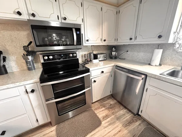 a kitchen with cabinets and appliances