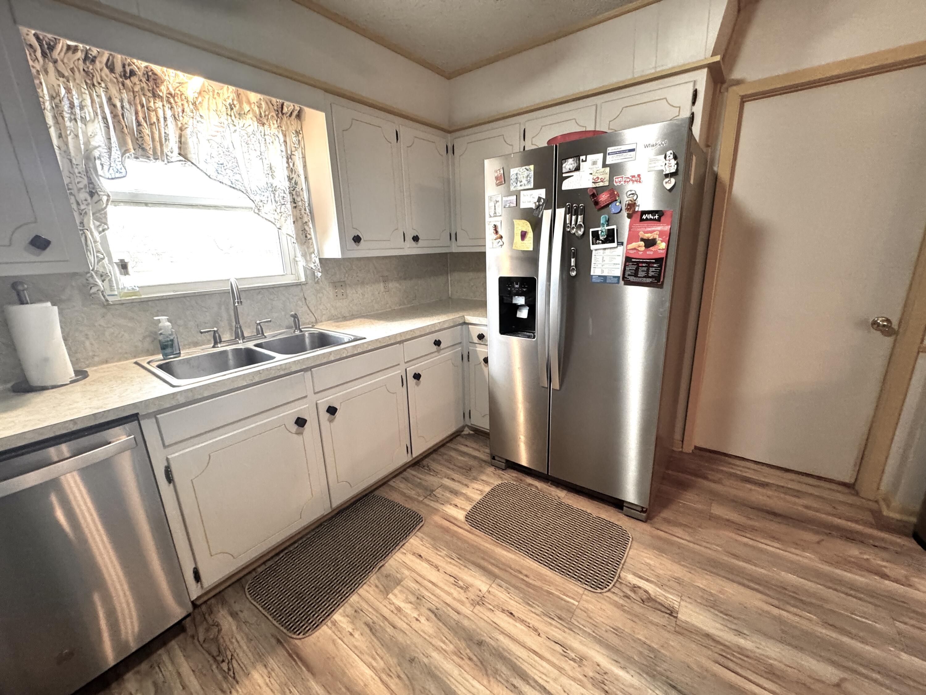 1720 Canyon Plainview, TX 79072 - Photo 22 of 49 a kitchen with stainless steel appliances a refrigerator sink and cabinets