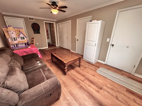 a living room with furniture and a wooden floor